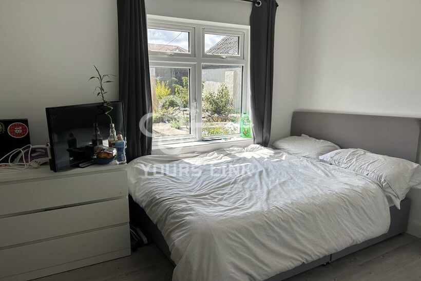 A bright and inviting double bedroom with ample...