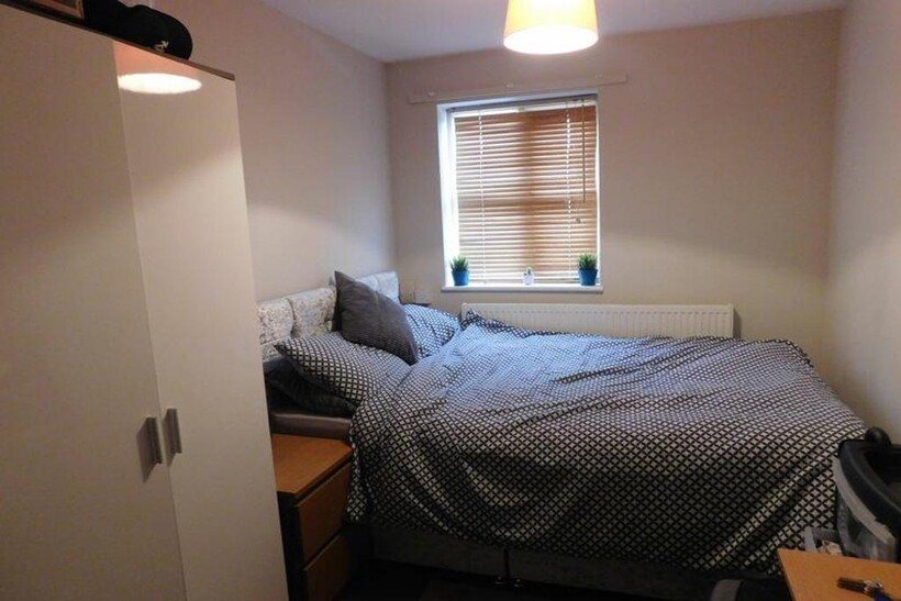 A cozy and inviting double bedroom with ample n...