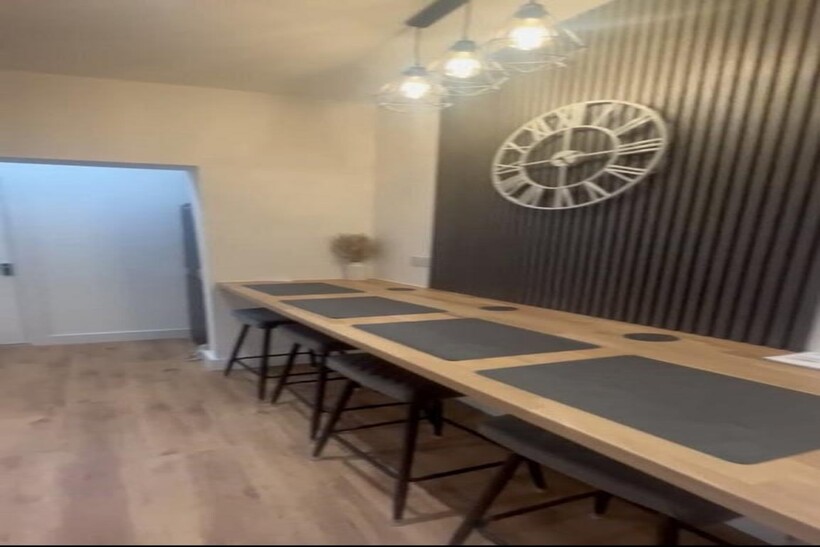 This stylish kitchen features a spacious counte...