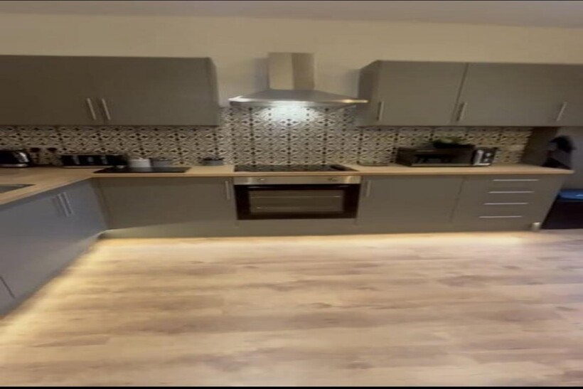 A modern kitchen featuring sleek cabinetry and ...