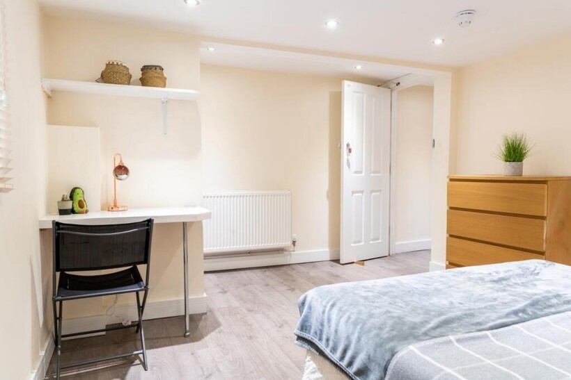 This inviting double bedroom features a comfort...