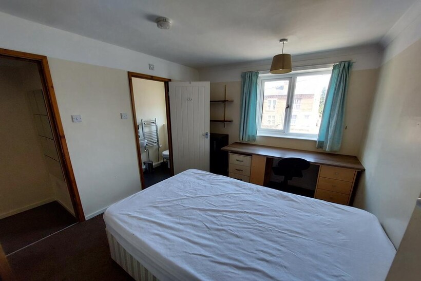 Spacious double bedroom featuring ample natural...