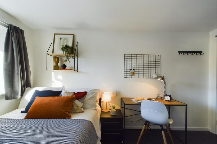 A bright and inviting double bedroom featuring ...