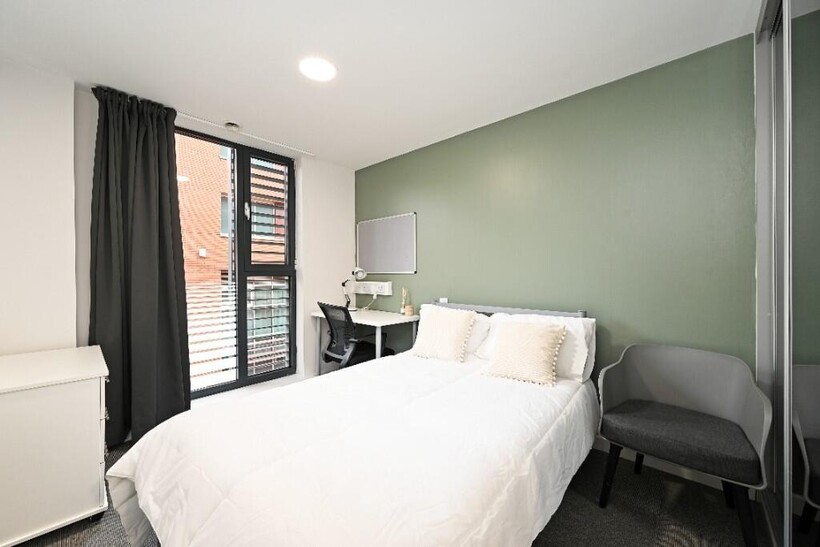 Bright and modern bedroom featuring a comfortab...