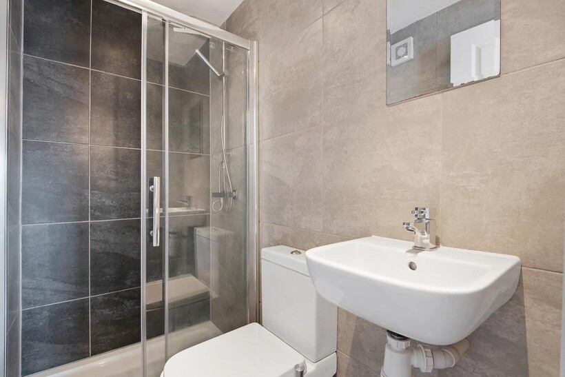 A modern and clean bathroom suite featuring a s...