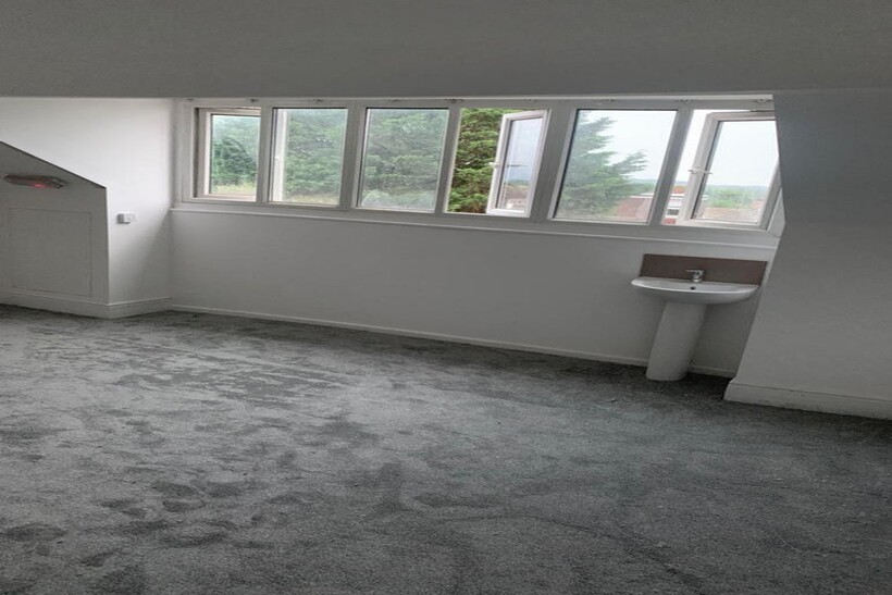 This inviting double bedroom features large win...