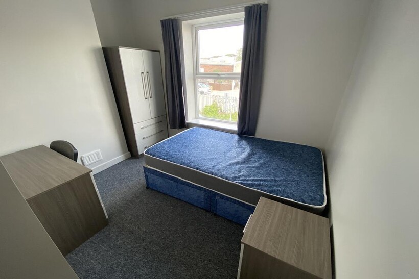 Cozy double bedroom featuring a comfortable bed...
