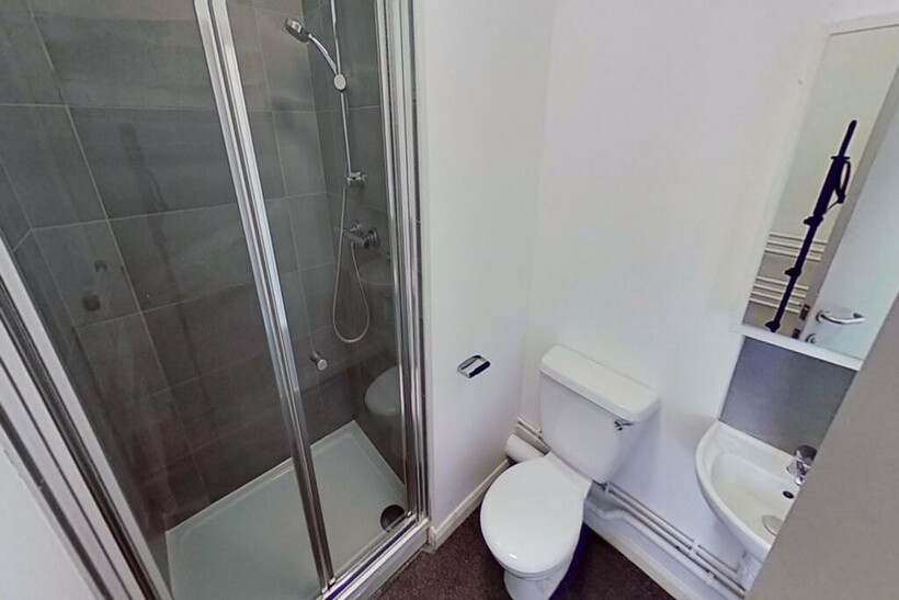 A modern bathroom featuring a sleek shower, sty...