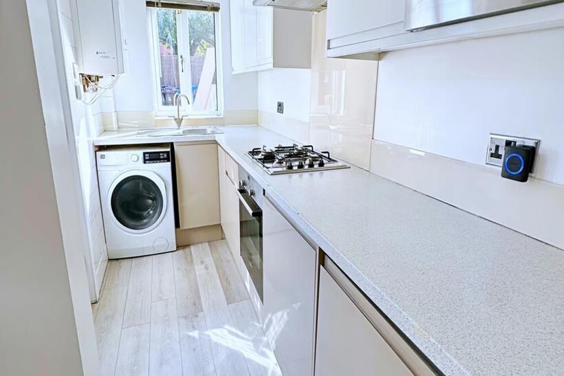 This modern kitchen features sleek cabinetry an...