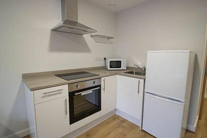 This modern kitchen features sleek cabinetry, a...