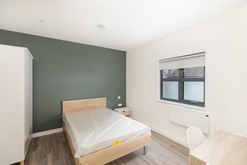 A bright and modern double bedroom featuring a ...