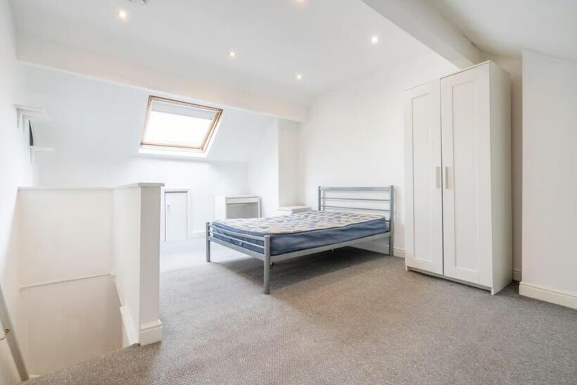 Bright and spacious double bedroom featuring a ...