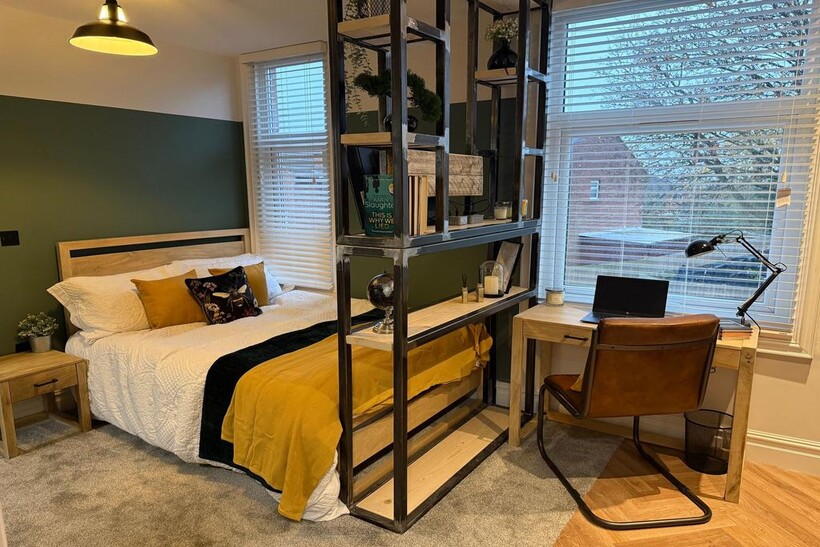 Bright and stylish master bedroom featuring a c...