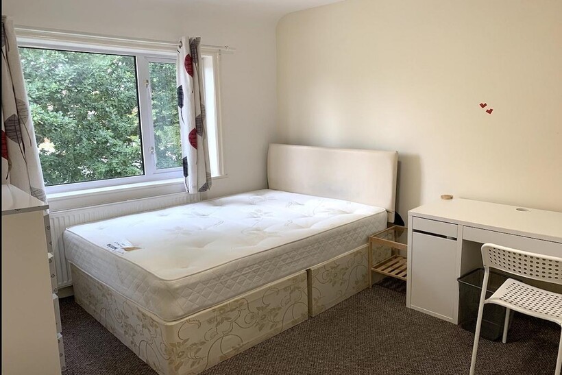 Bright and tidy double bedroom featuring a comf...
