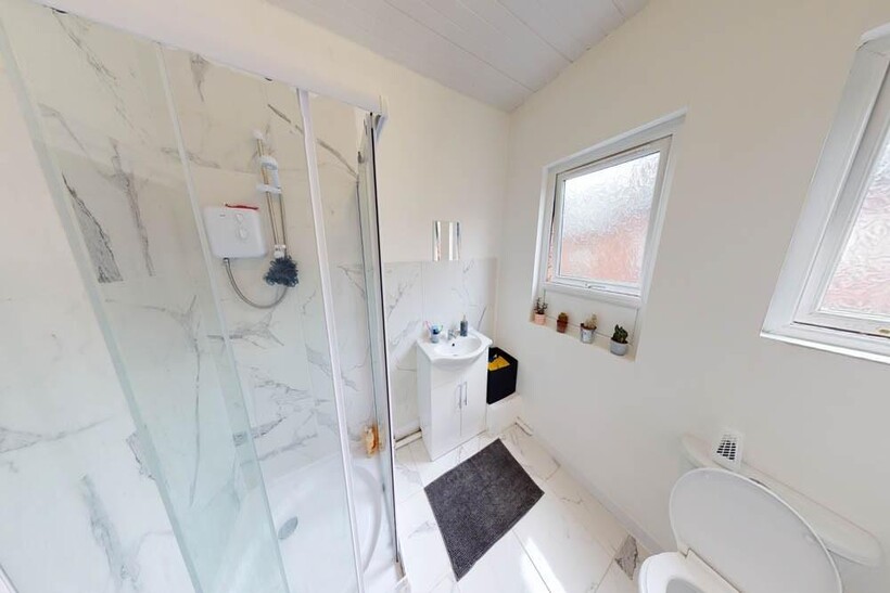Bright and modern bathroom suite featuring a sp...