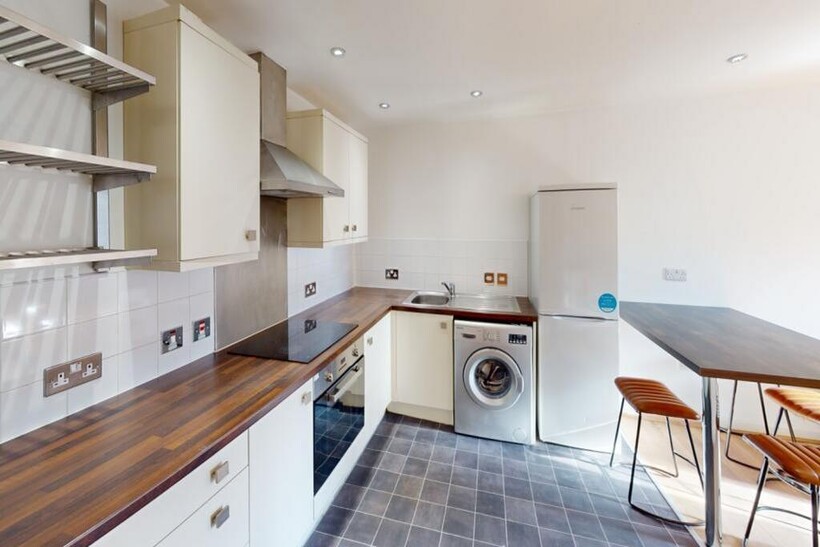 A modern and spacious kitchenette with ample st...