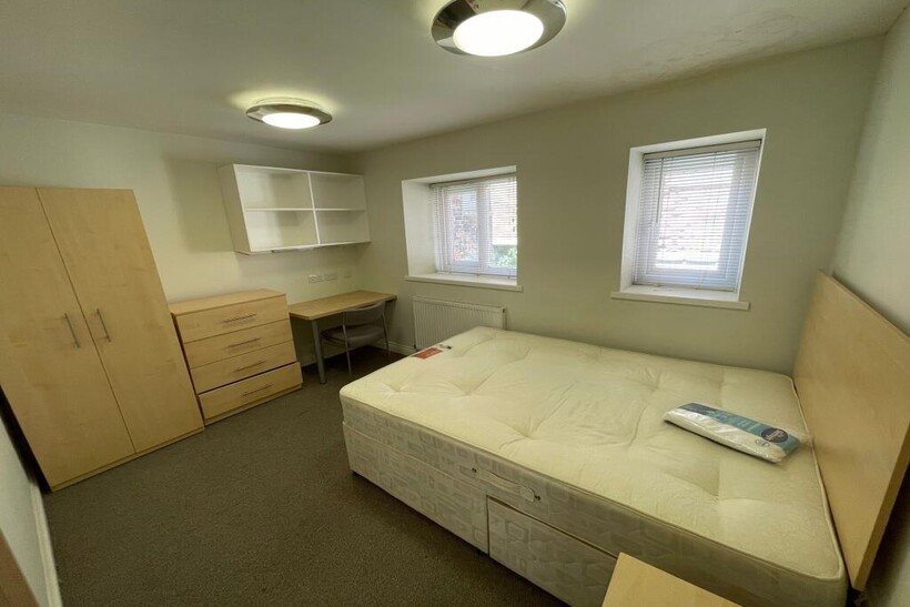 A bright and inviting master bedroom featuring ...
