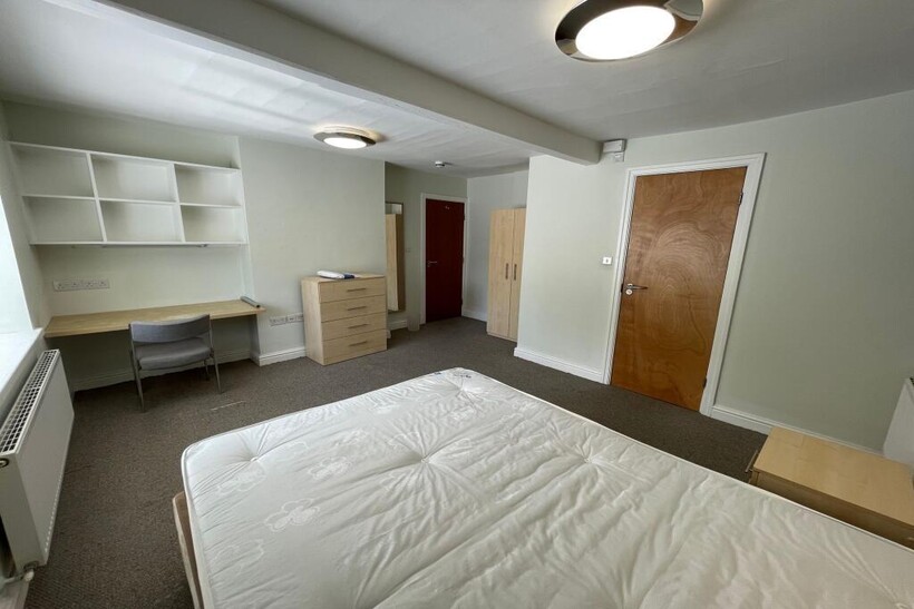 Bright and tidy double bedroom featuring a comf...