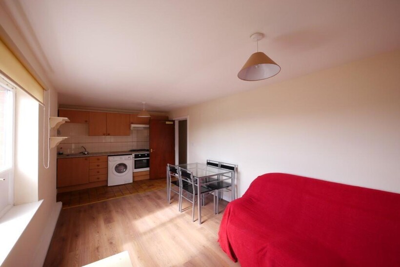 A bright and tidy living space featuring a comp...
