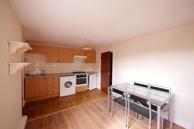 A bright and tidy kitchen area featuring modern...