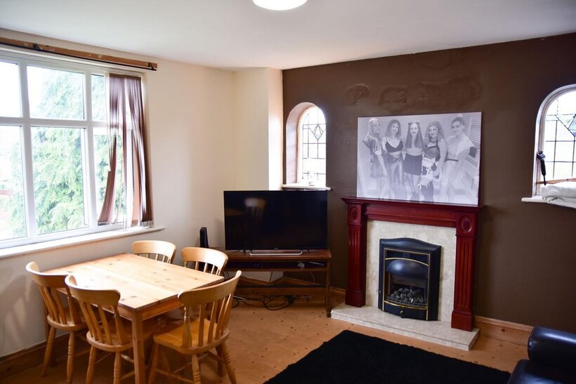 A cozy living room featuring a wooden dining ta...