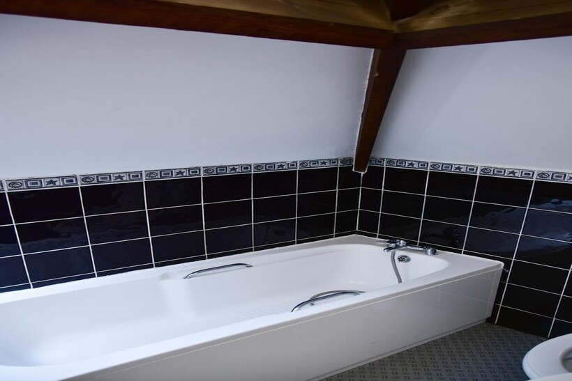 Bright bathroom suite featuring a clean, white ...