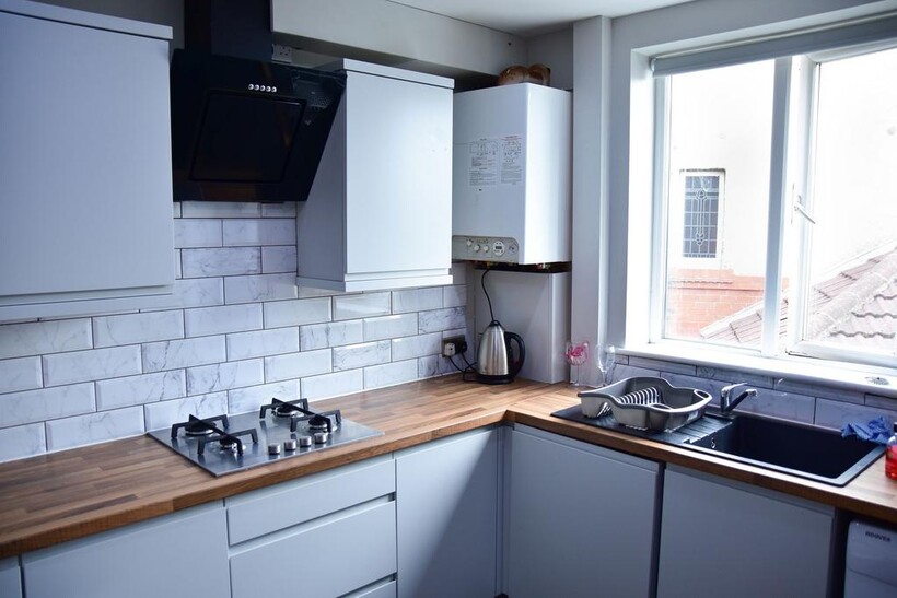 Bright and modern kitchen with sleek white cabi...