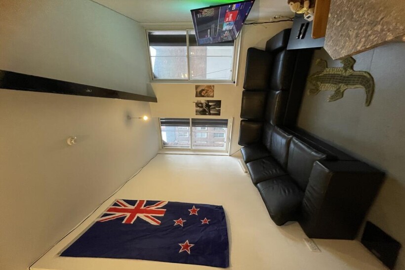 A modern living room featuring a large black le...