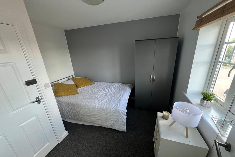 A cozy double bedroom featuring a comfortable d...