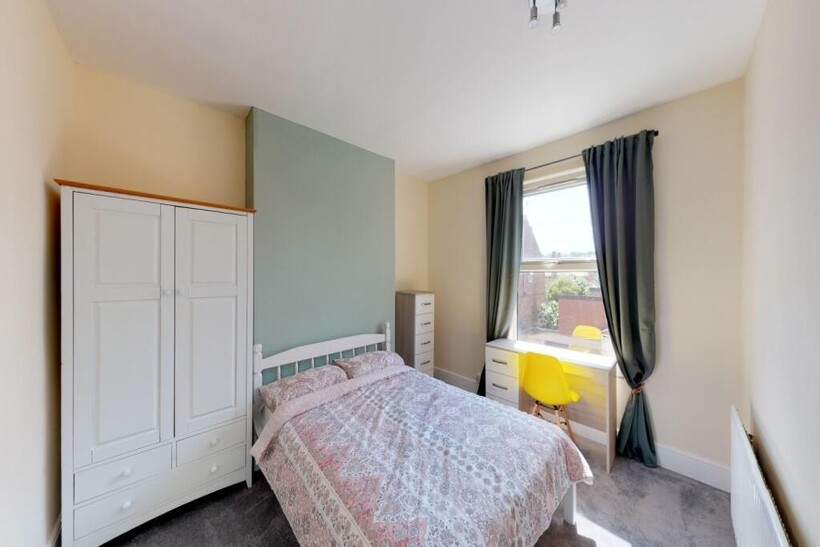 Bright and cozy double bedroom featuring a comf...