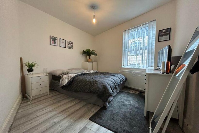 A bright and tidy double bedroom featuring styl...