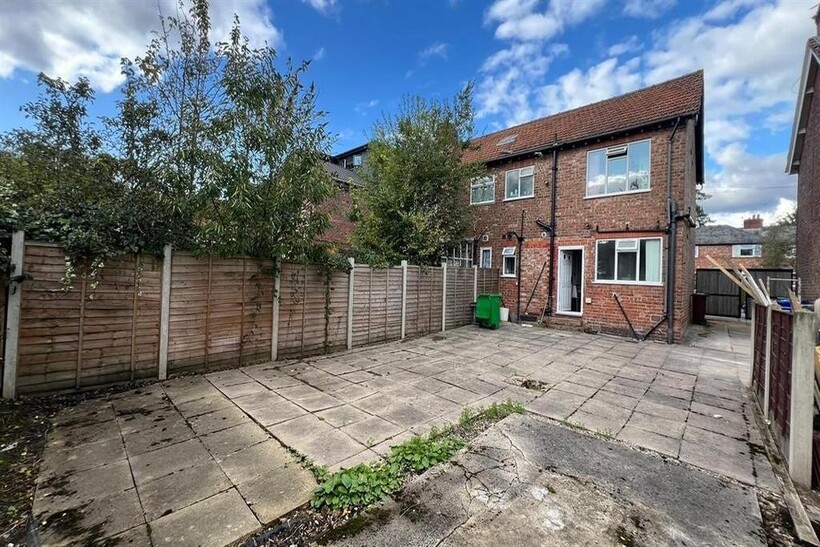 A spacious and well-maintained paved garden are...