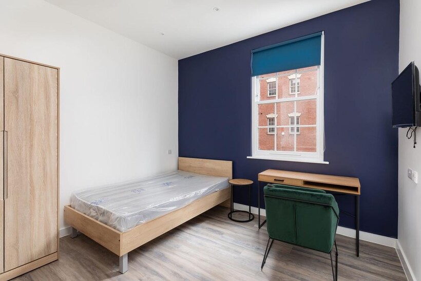 A stylish and well-lit double bedroom featuring...