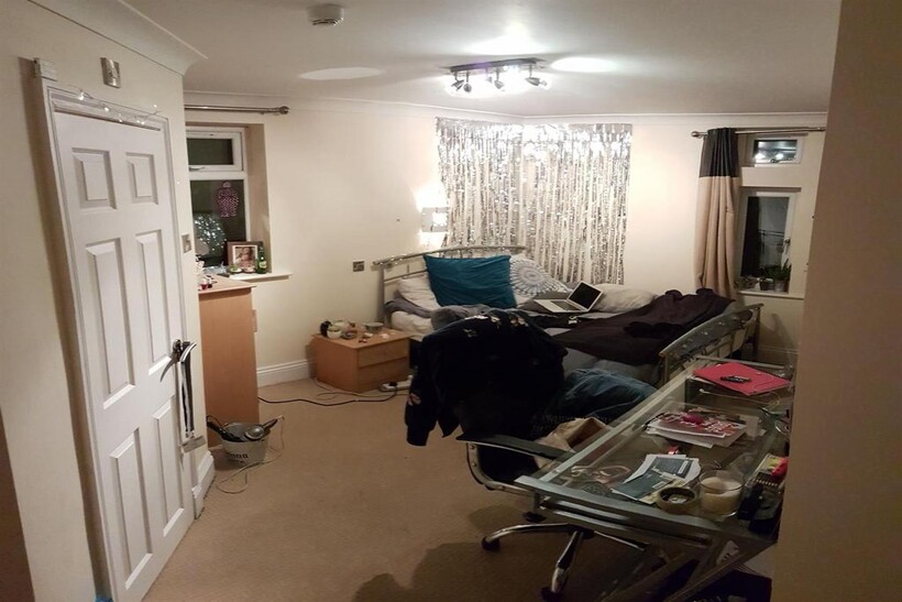 Cozy and functional bedroom featuring a comfort...