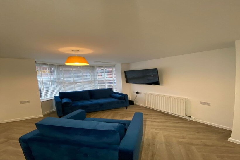 A bright, modern living room featuring a large ...