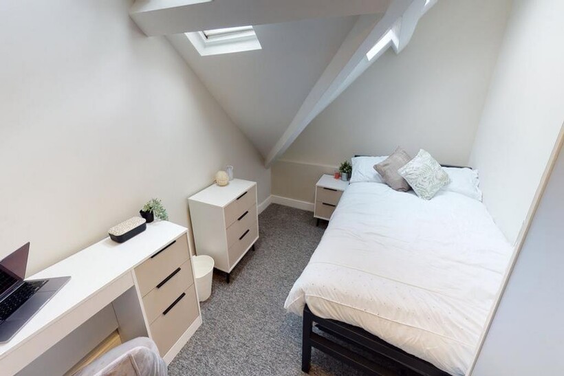 A bright and tidy double bedroom featuring a co...