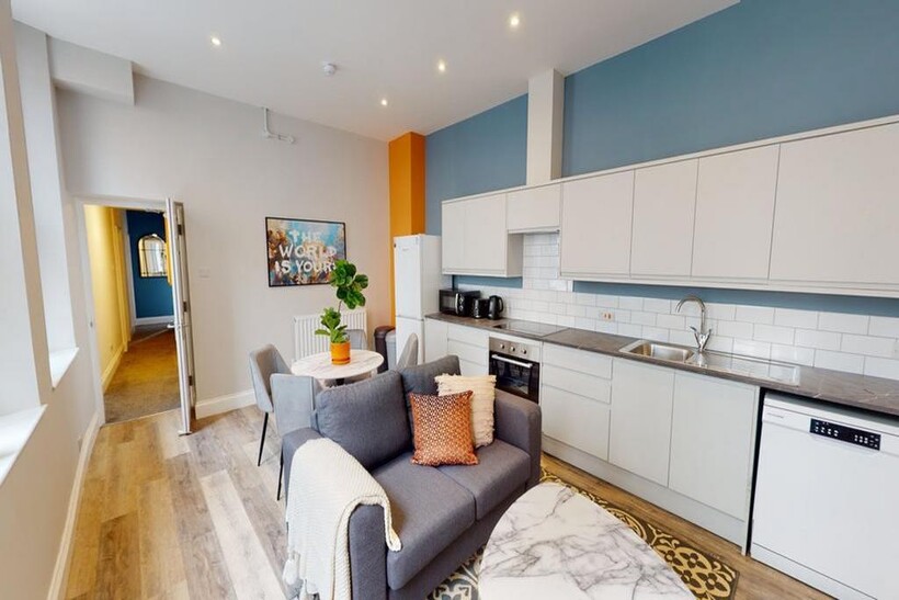 A bright and modern kitchenette with stylish de...