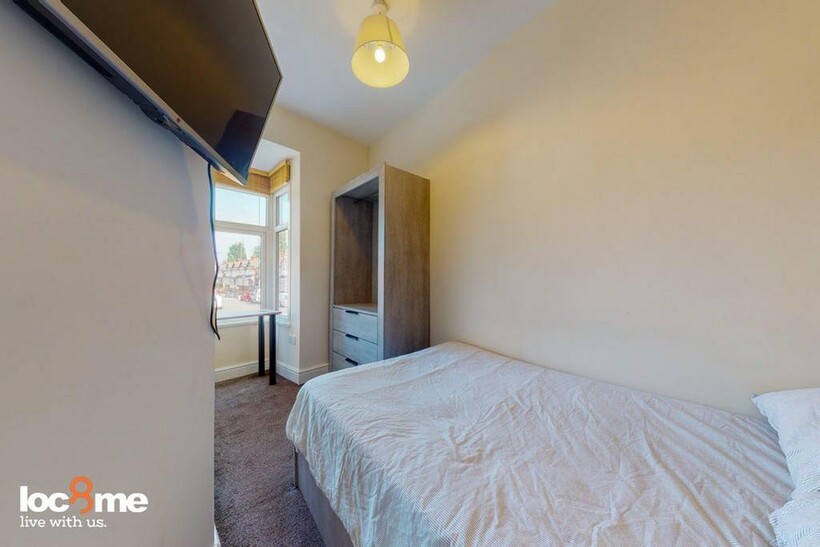 A bright and inviting double bedroom with ample...