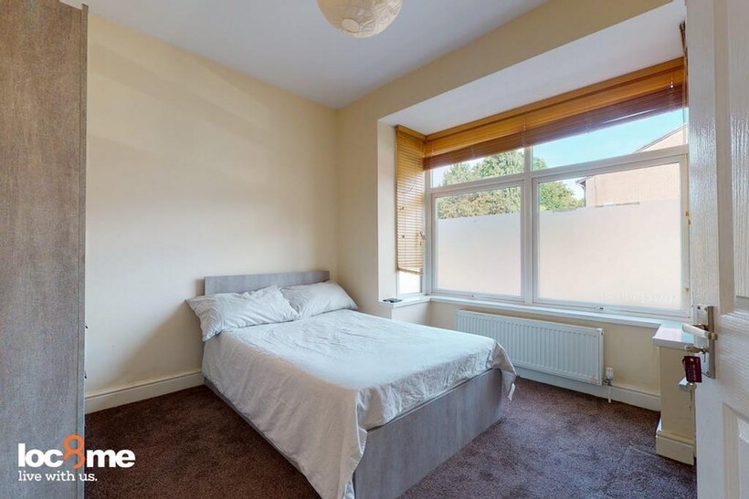 A bright and inviting double bedroom featuring ...