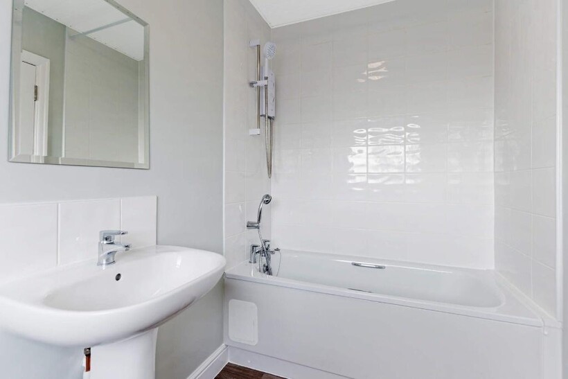 Bright and clean bathroom featuring a modern wh...