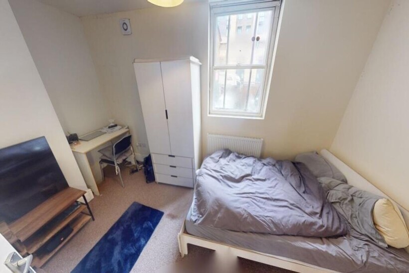 Cozy single bedroom featuring a comfortable sin...