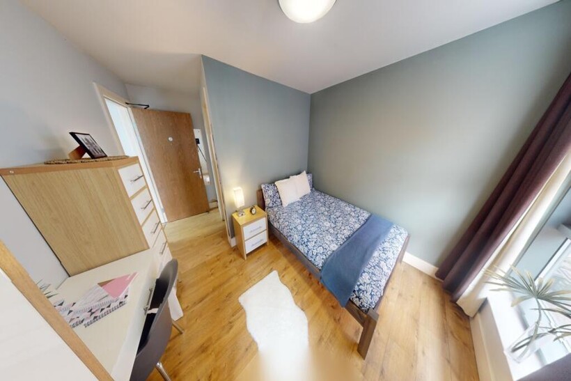 Bright and tidy single bedroom featuring a cozy...