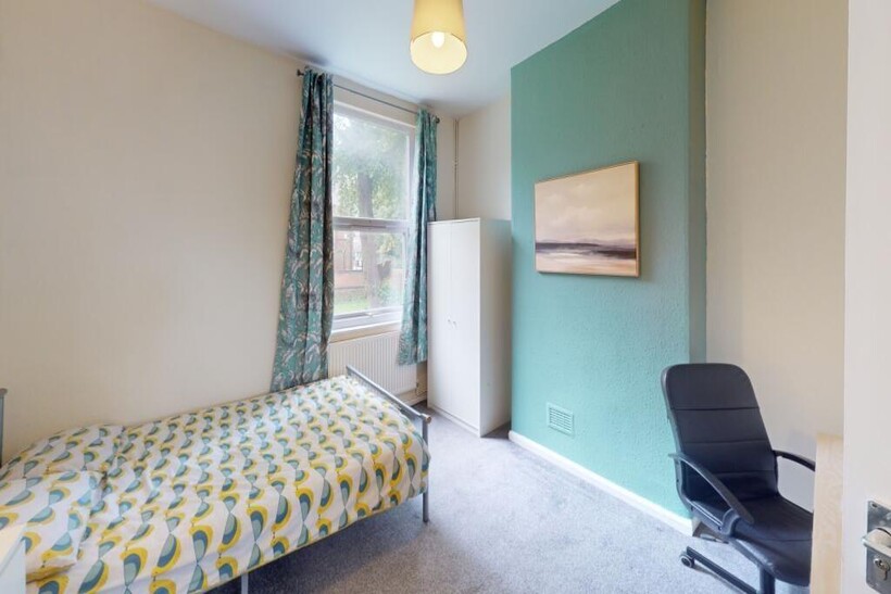 Bright and cozy single bedroom featuring a comf...