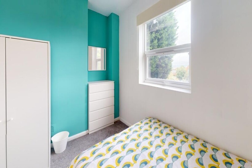 A bright and tidy single bedroom featuring a co...