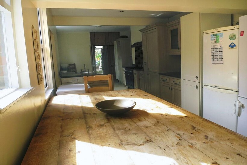 Bright and welcoming kitchen with ample natural...