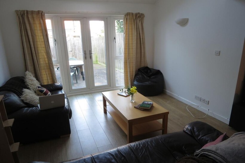 Bright and welcoming living room with large gla...