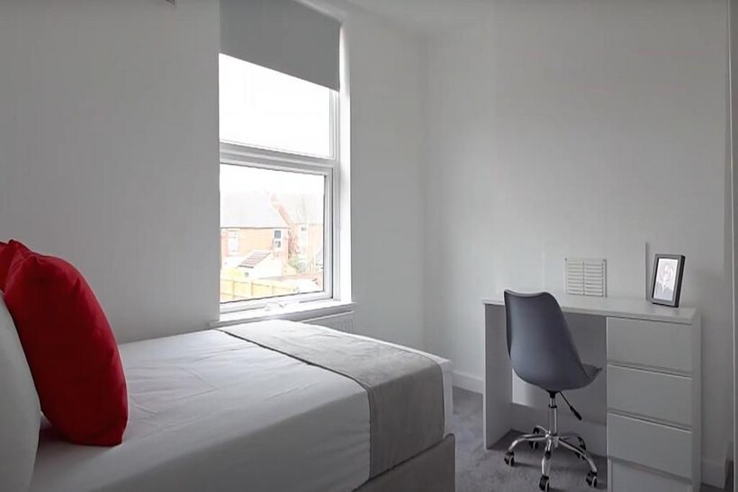 Minimalist single bedroom with a bright window ...