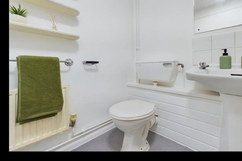 A clean and tidy single toilet with modern fixt...