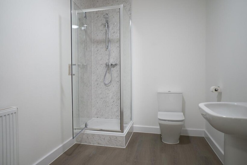 A modern and pristine bathroom featuring a spac...