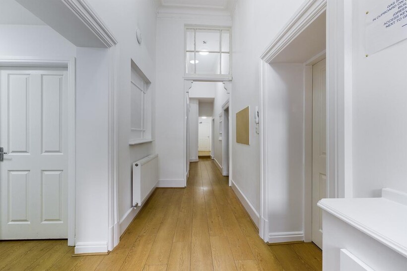 A bright and well-maintained hallway that welco...